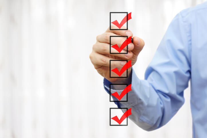 businessman checking final mark on checklist