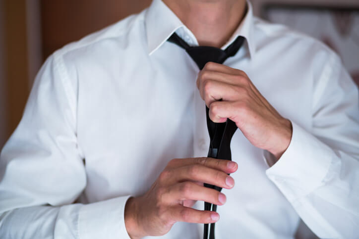 Young Business Man Fixing his Tie